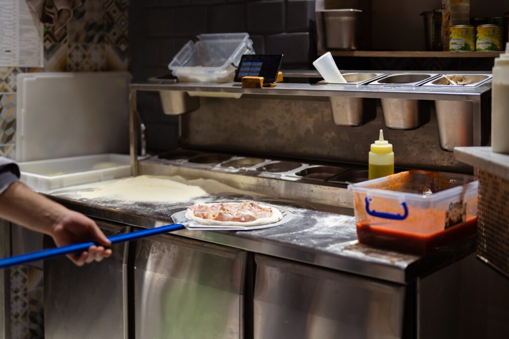 Pizza making process in the restaurant kitchen